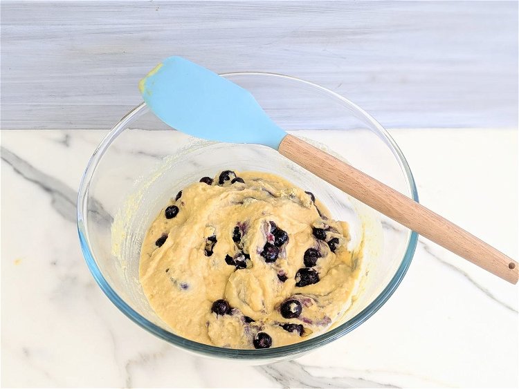 Image of Gently fold the blueberries into the batter, this way the...