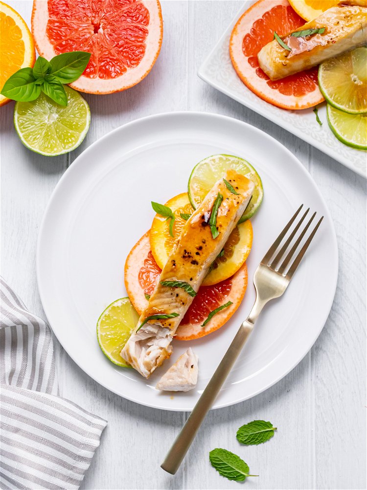 Image of Arrange sliced citrus on a plate or platter and top...