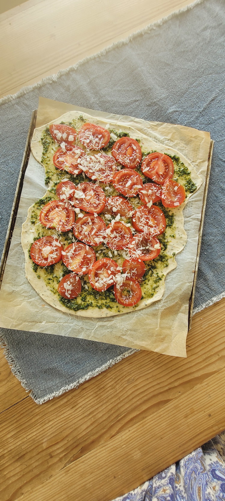 Image of Jetzt legst du die Tomatenscheiben auf die Pesto. Achte darauf, nicht bis ganz an den Teigrand zu belegen. Der wird zum Schluss umgeklappt