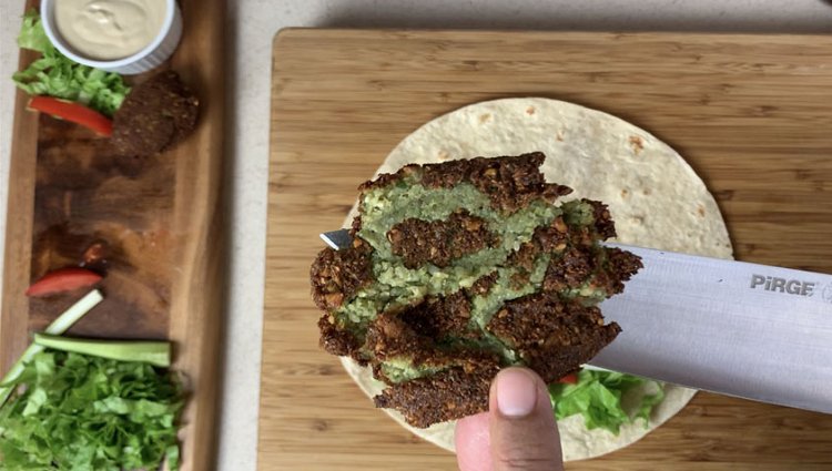 Image of Take one tortilla and fill it with some vegetables.