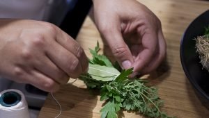 Image of Tie all the herbs with kitchen twine. Set aside.