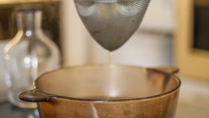 Image of Strain the stock through the sieve.