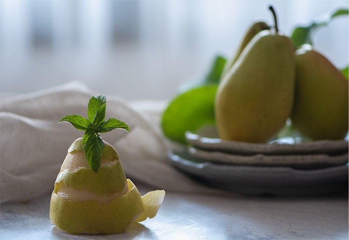 Image of Wash the pears and peel them, leaving only the stalks.