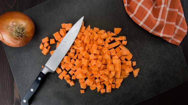 Image of Place the chopped sweet potatoes and carrots into a pan....