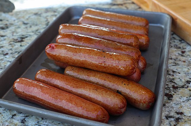 Image of Place chili and hotdogs on the cooking grate and smoke...