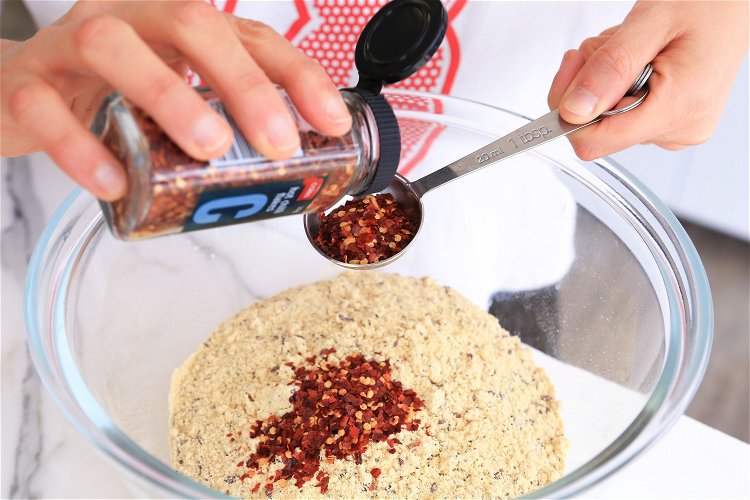 Image of 2Combine the dry ingredients (bread mix, parmesan, chilli flakes) into...