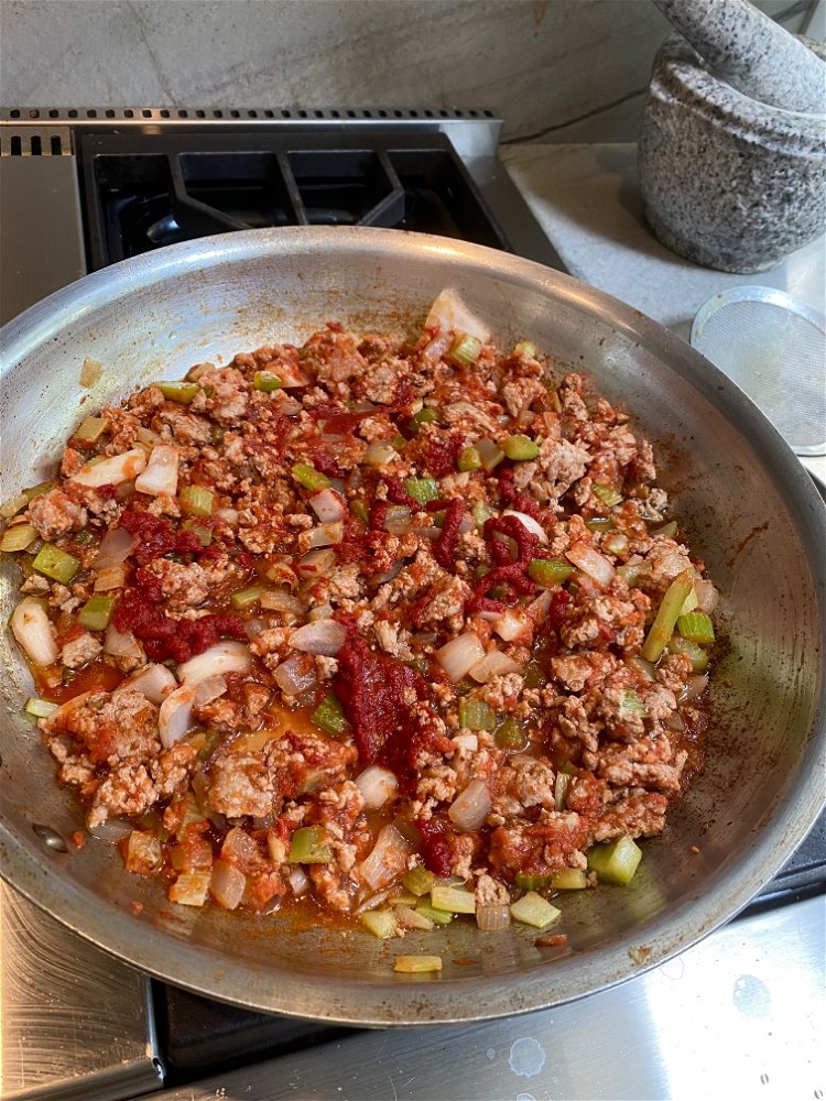 Image of Add ground meat back to pan. Add the canned tomatoes,...