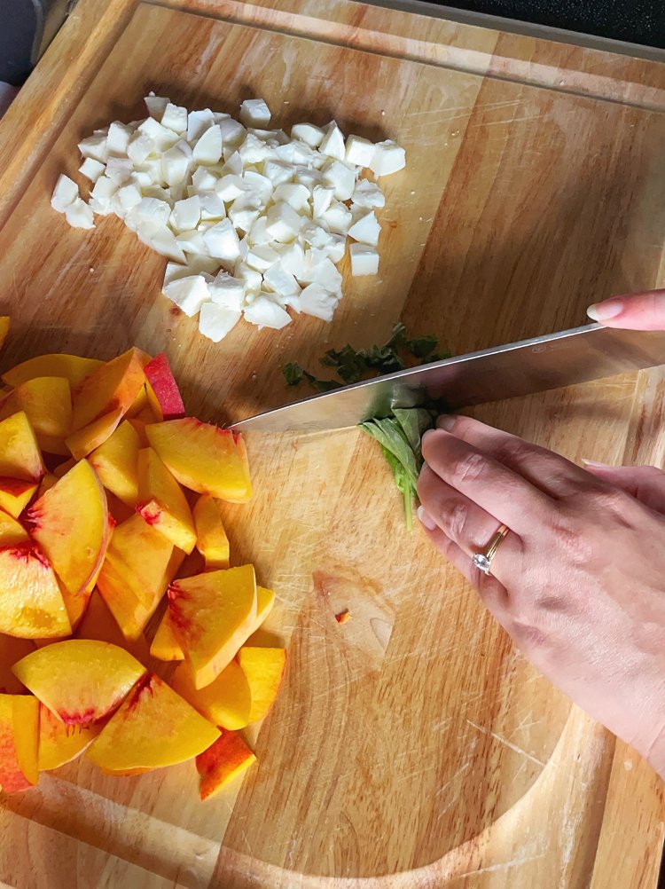 Image of Cut peaches into half slices, cube mozzarella, and roughly chop...