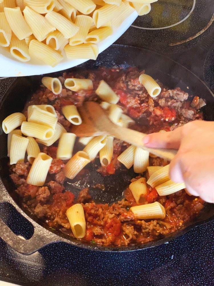 Image of Add cooked pasta to skillet and stir to combine with...