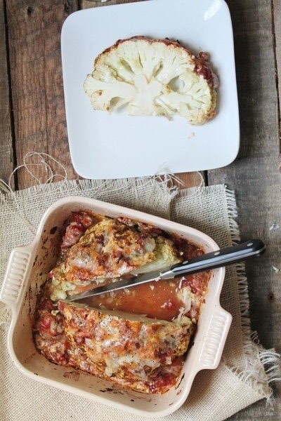 Whole Roasted Cauliflower with Cheddar, Pesto and Tomatoes