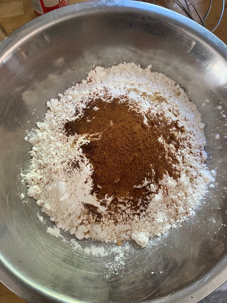Image of Whisk together dry ingredients: flour, soda, ground ginger, cinnamon, cloves,...