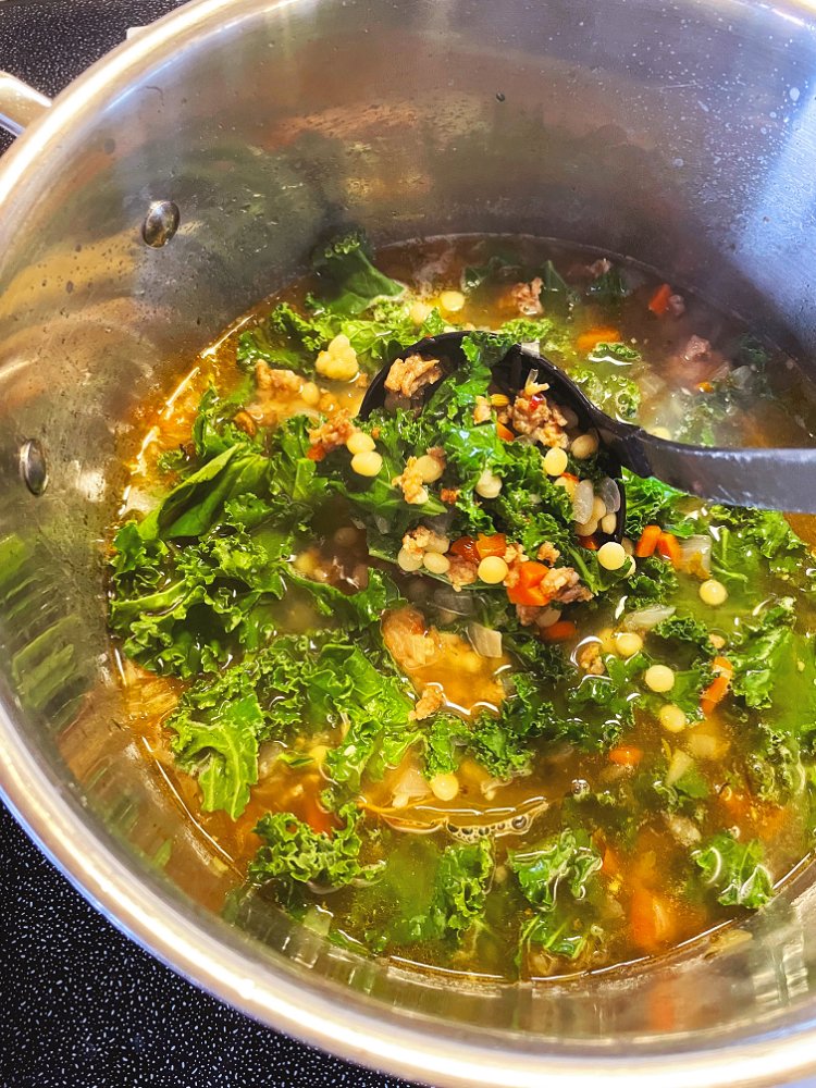Image of Remove bay leaves and thyme sprigs, stir in kale and...