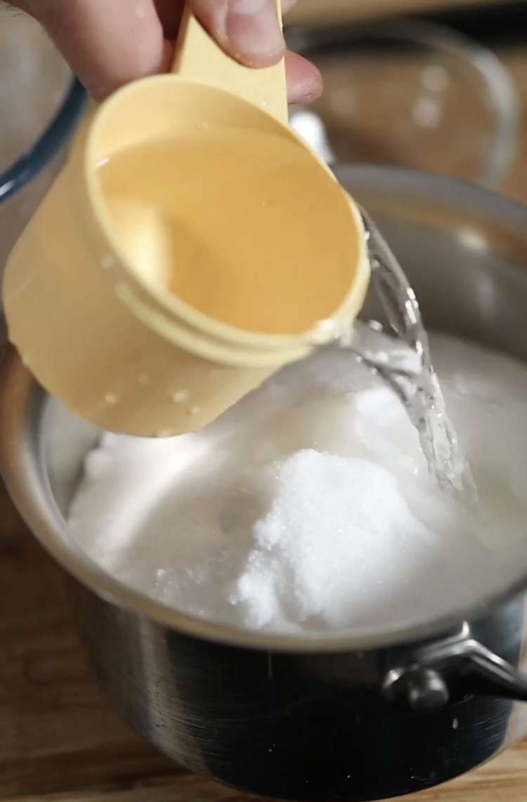 Image of In a pot add - 3c caster sugar, 1 tsp vinegar, 1/4c glucose and 3/4c warm water. Keep at low heat until the sugar dissolves (approx 5 mins)