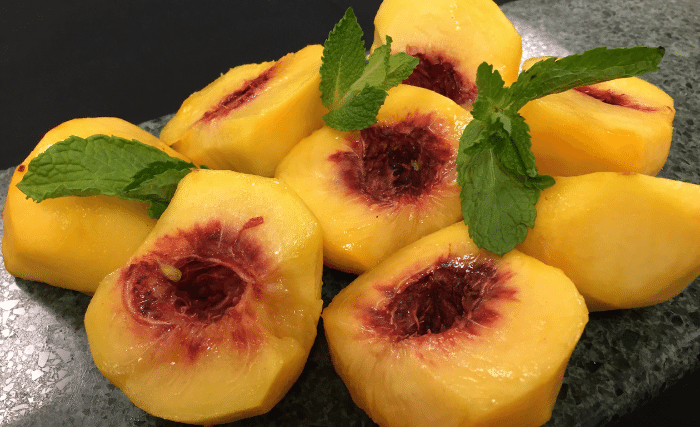 Image of Blanch peaches, cool in cold water. Then peel, pit, and...