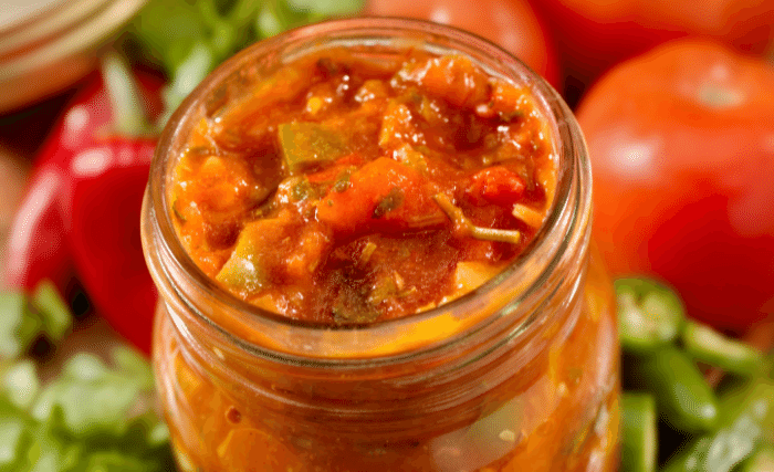 Image of Ladle hot salsa into your prepared jars, leaving 1/2 inch...