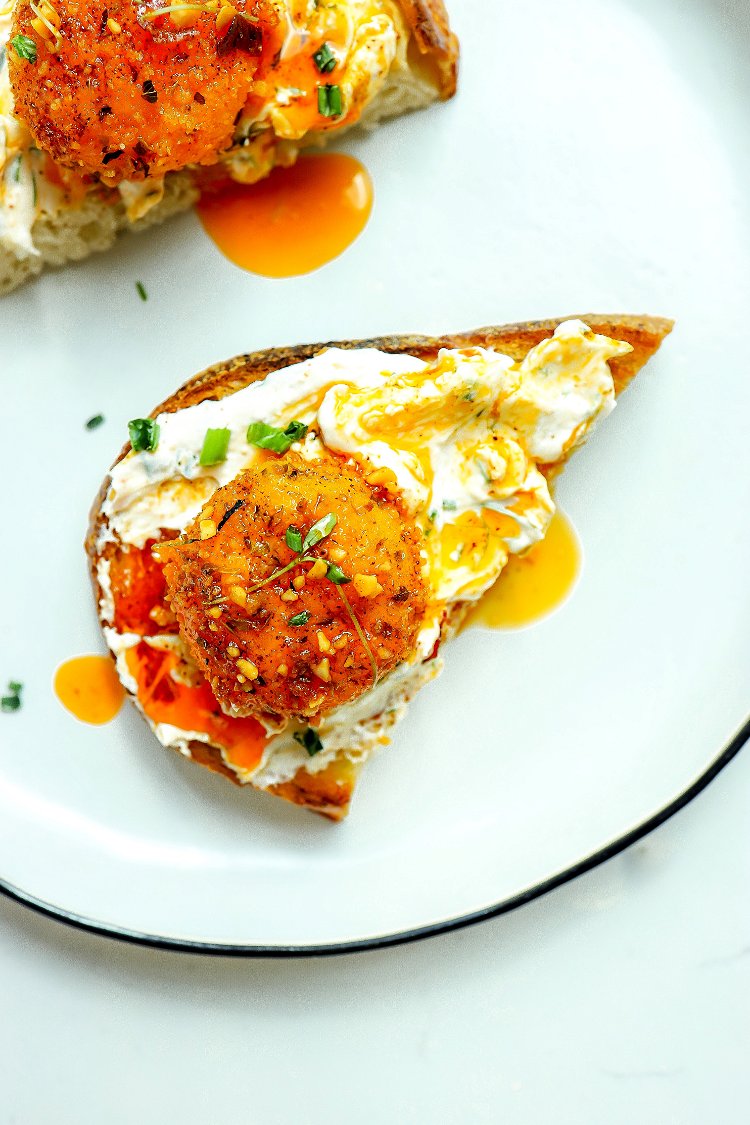 Image of Toast the bread, spread the labneh on a plate, add...