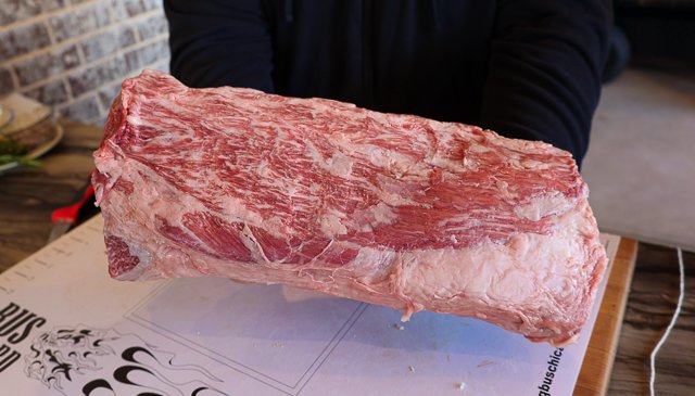 Image of Trim excess fat from loin and use butcher twine to...