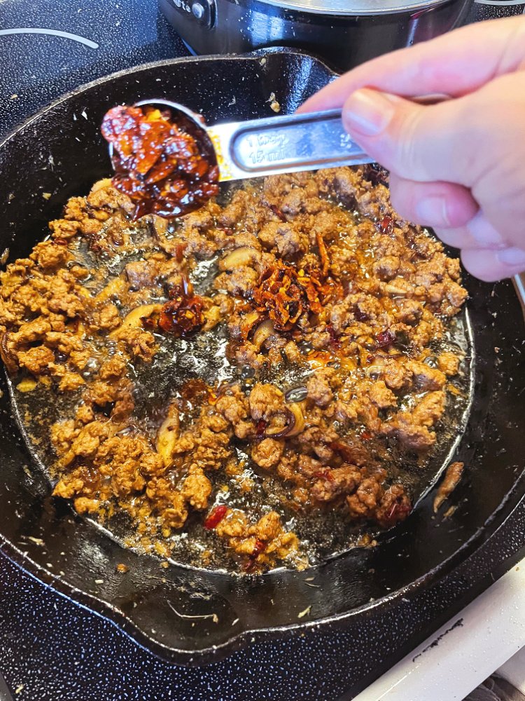 Image of Add chili crisp, stir and let cook until combined well,...