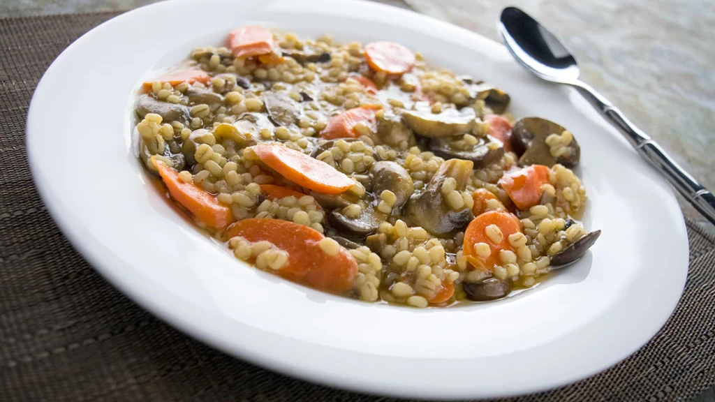 Image of Spicy Garlic Roasted Carrot-Barley Risotto with Caramelized Onions and Leeks
