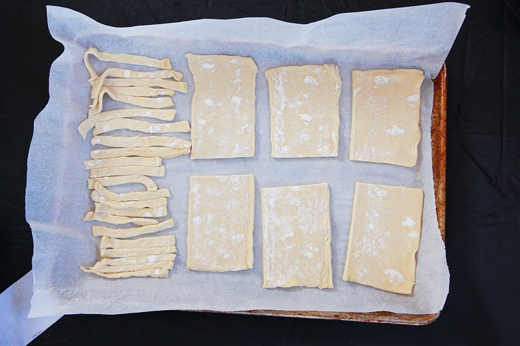 Image of Use a knife to slice the puff pastry dough into 6 rectangles (about 3”x4”) and 20-24 strips (about ½” x 3”). (About 1.5 puff pastry sheets should be enough)