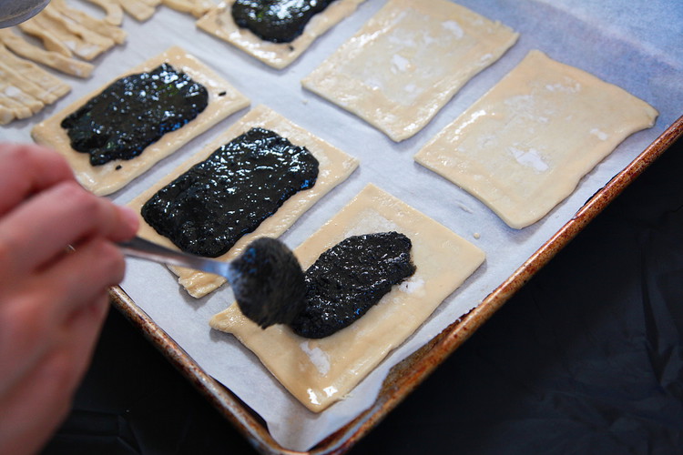 Image of Brush the edges of each pop tart base with egg wash. Add a tablespoon of Black Sesame Crunchy Butter to the center and spread it but leave a half inch to the edges