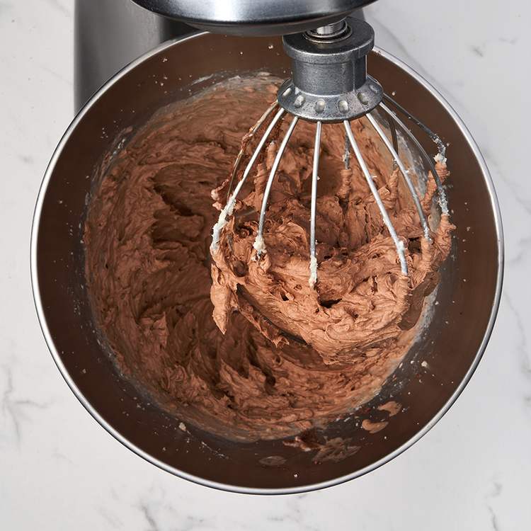 Image of Slowly pour in half the heavy cream, whisking until a whipped texture is achieved. Tip: It’s helpful to add the heavy cream not all at once. Make sure to scrape the sides down so nothing gets left behind. 