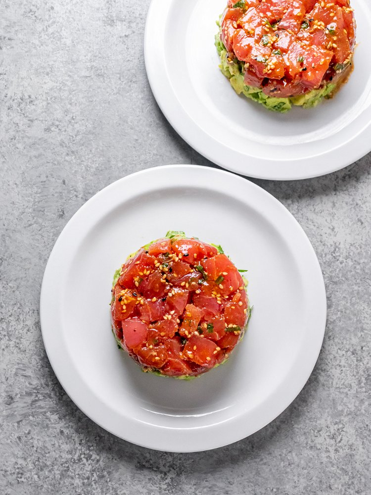 Image of Divide avocado on top of tuna layer and press to...
