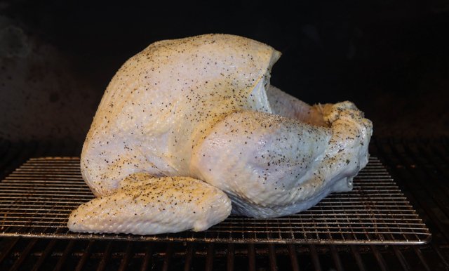 Image of Place the turkey in the smoker breast side up until...
