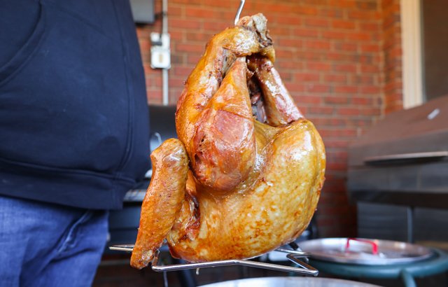 Image of Carefully lower the turkey breast side down into the hot...