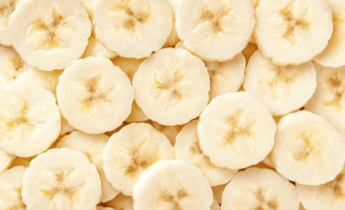Image of Arrange banana slices in a single layer on dehydrator trays,...
