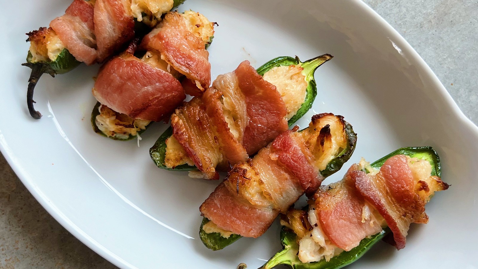 Image of Crab Stuffed Jalapeno Poppers Wrapped in Bacon