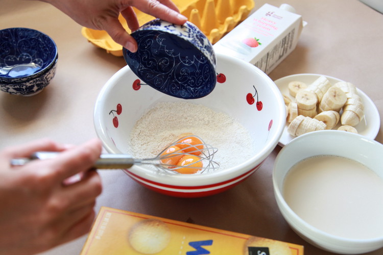 Image of Add egg yolks and half the milk and mix until smooth.