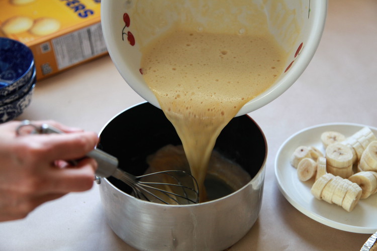 Image of Transfer the mixture back into the pan with remaining milk and whisk. Cook for 5-10 min or until pudding has thickened on medium low heat.