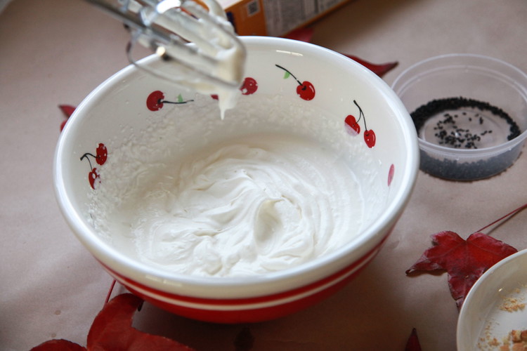 Image of To make the whipped cream, pour in the whipped cream and sugar in a medium mixing bowl and use a handheld mixer to whip the cream until stiff peaks.