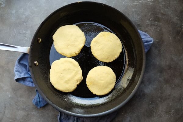 Image of On a lightly floured surface, portion the arepa dough into pieces...