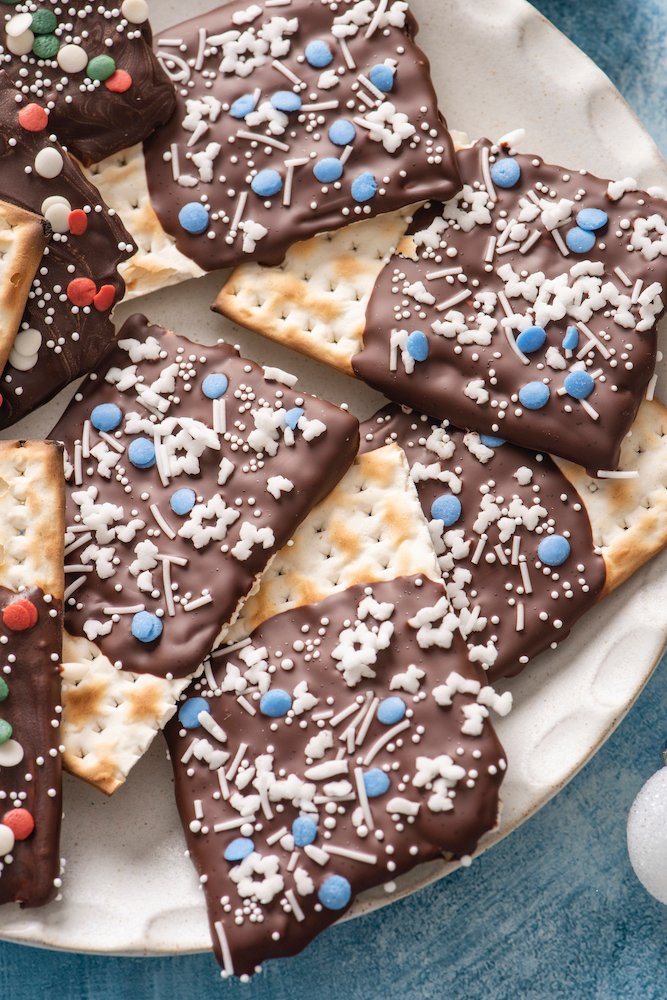 Image of Sprinkle the chocolate dipped pieces of matzo with sprinkles and...