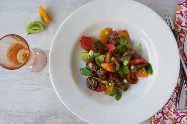 Image of Grilled Tenderloin Steak Tips with Heirloom Tomatoes and Avocado Dressing