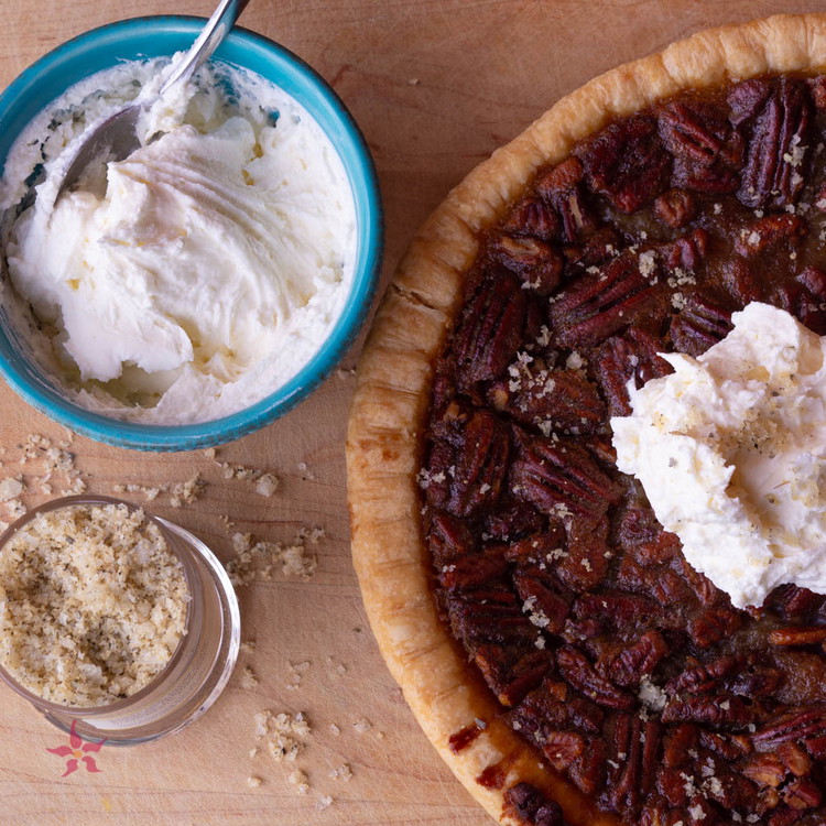 Image of Preheat oven to 350°F. Whisk eggs and sugar in a medium bowl. Mix in maple syrup, brown sugar, eggs, melted butter, flour, vanilla extract and chopped pecans.Spread your crust over a cast iron skillet. Pour filling into crust. Carefully place pecan halves on top. (Optional...