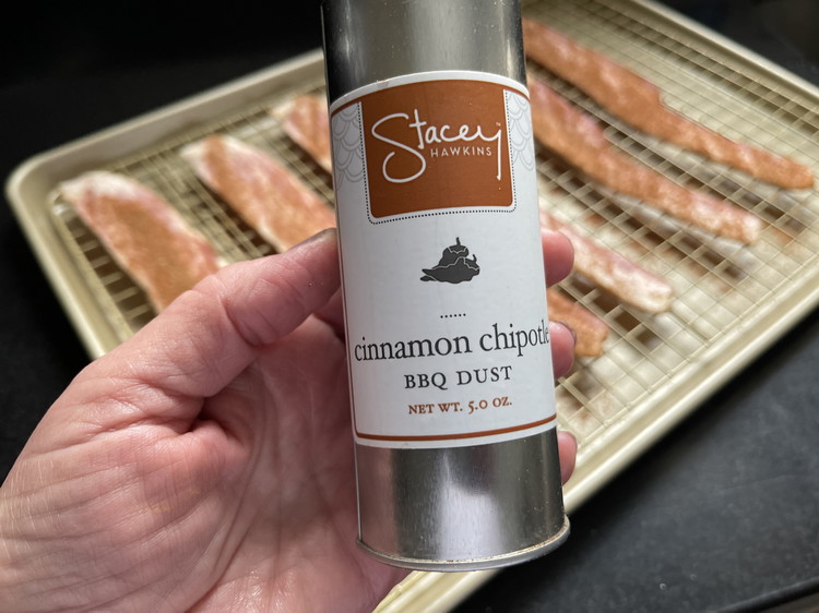 Image of Place a baking rack over a sheet pan. Lay bacon pieces individually on the rack, being careful not to overlap.