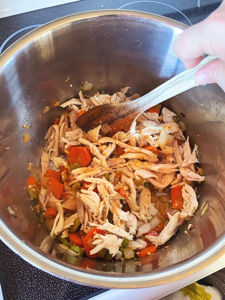 Image of Add shredded chicken and toss with veggies for a couple...