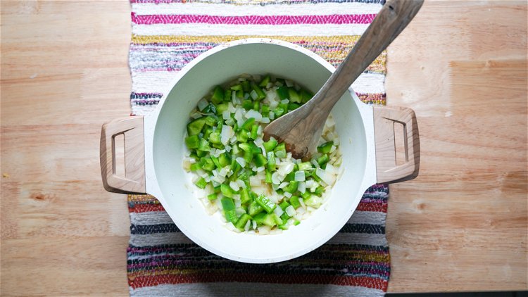 Image of Saute finely chopped onions and green peppers in butter until...