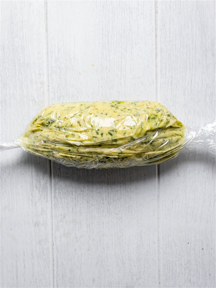 Image of Spoon pesto butter on a large piece of plastic wrap...