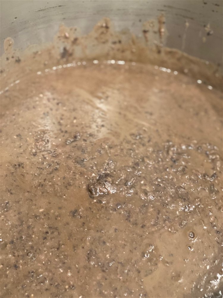 Image of Add the puree and the removed bean mixture back into...