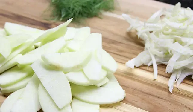Image of Combine sliced apples, fennel, lemon juice and sugar in a...