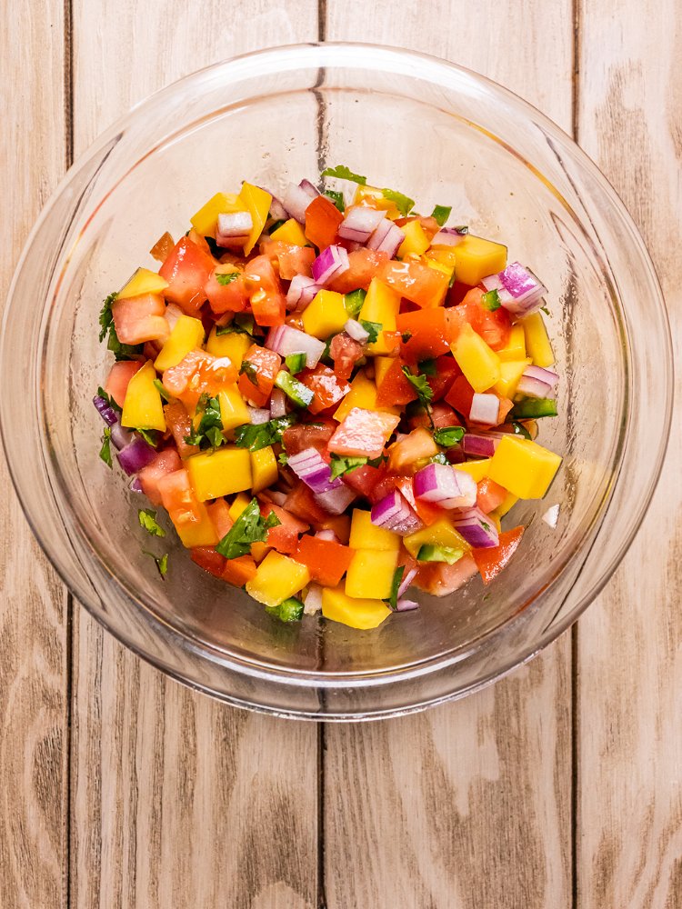 Image of Combine ingredients for mango salsa in a medium bowl and...