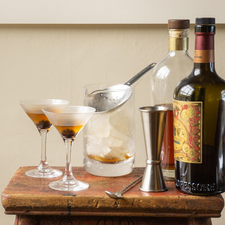 Image of Pour everything but the cherry over ice in a chilled mixing glass.
