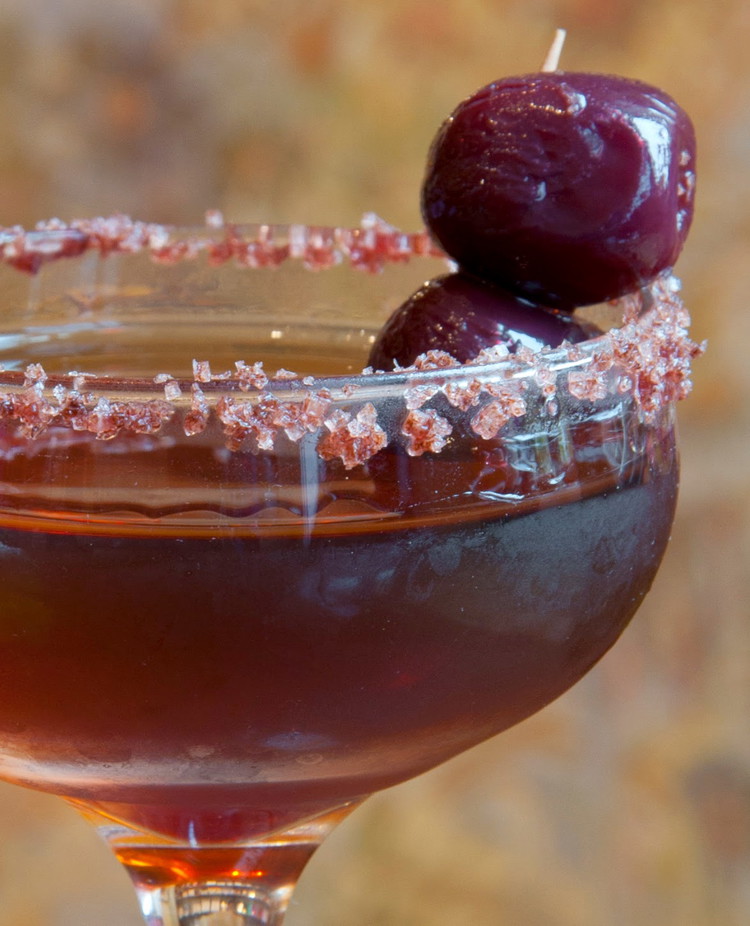 Image of Stir for 15 seconds, then strain into chilled coupe glasses. Garnish with the cherries.