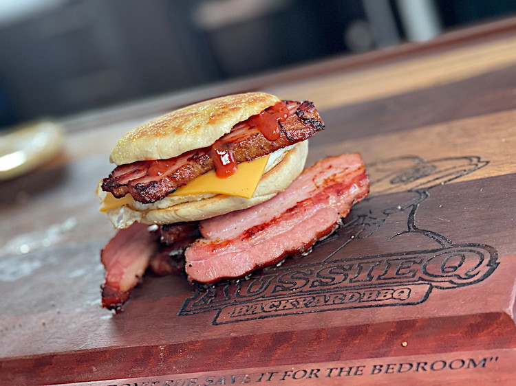 Image of Muffin, egg, cracked pepper, american cheese, bacon, ketchup, top muffin.