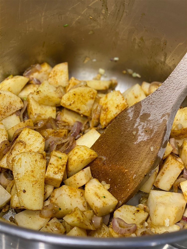 Image of Add the potato, madras curry powder, corriander, salt & pepper...