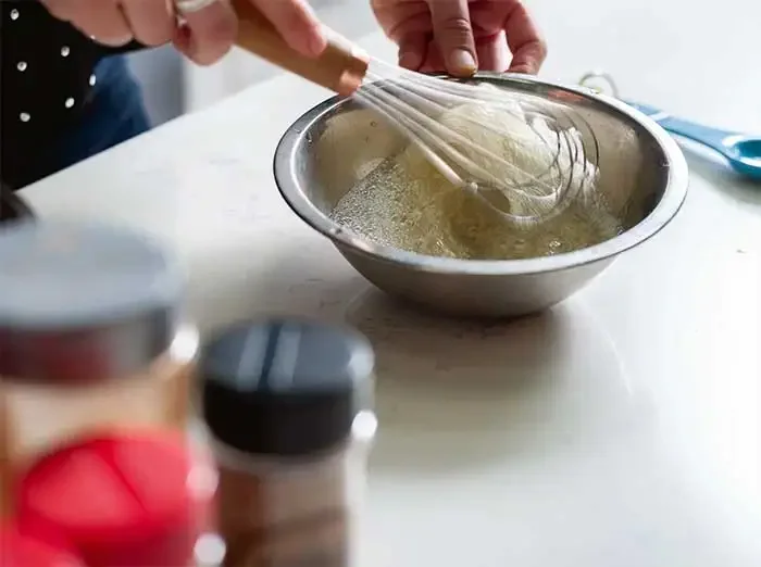 Image of Whipping the egg whites helps to evenly coat the nuts...